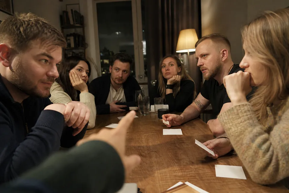 Two teams watching a clue-giver during a timed word round