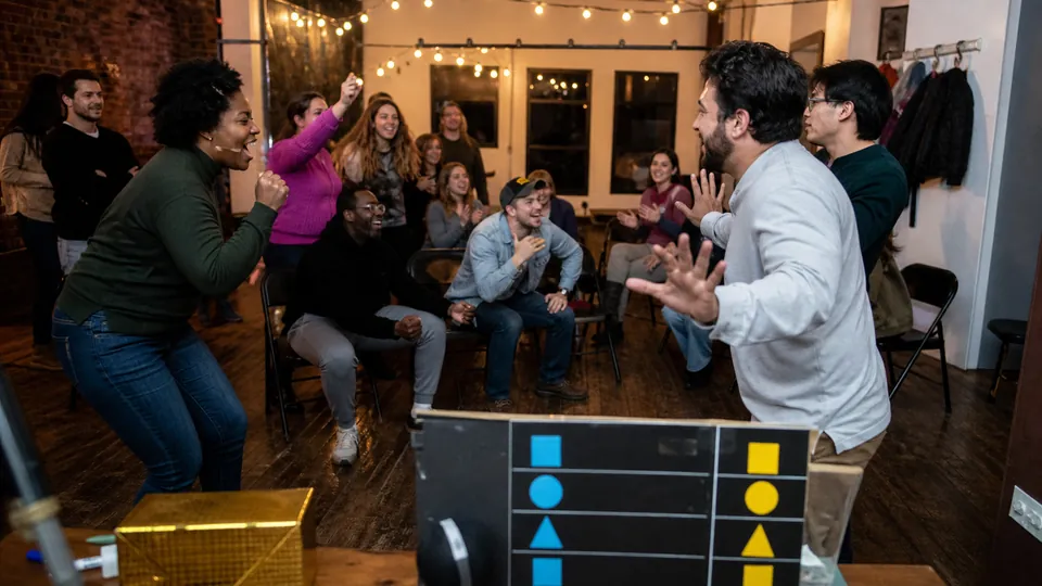 Two teams of friends playing a group game in a loft