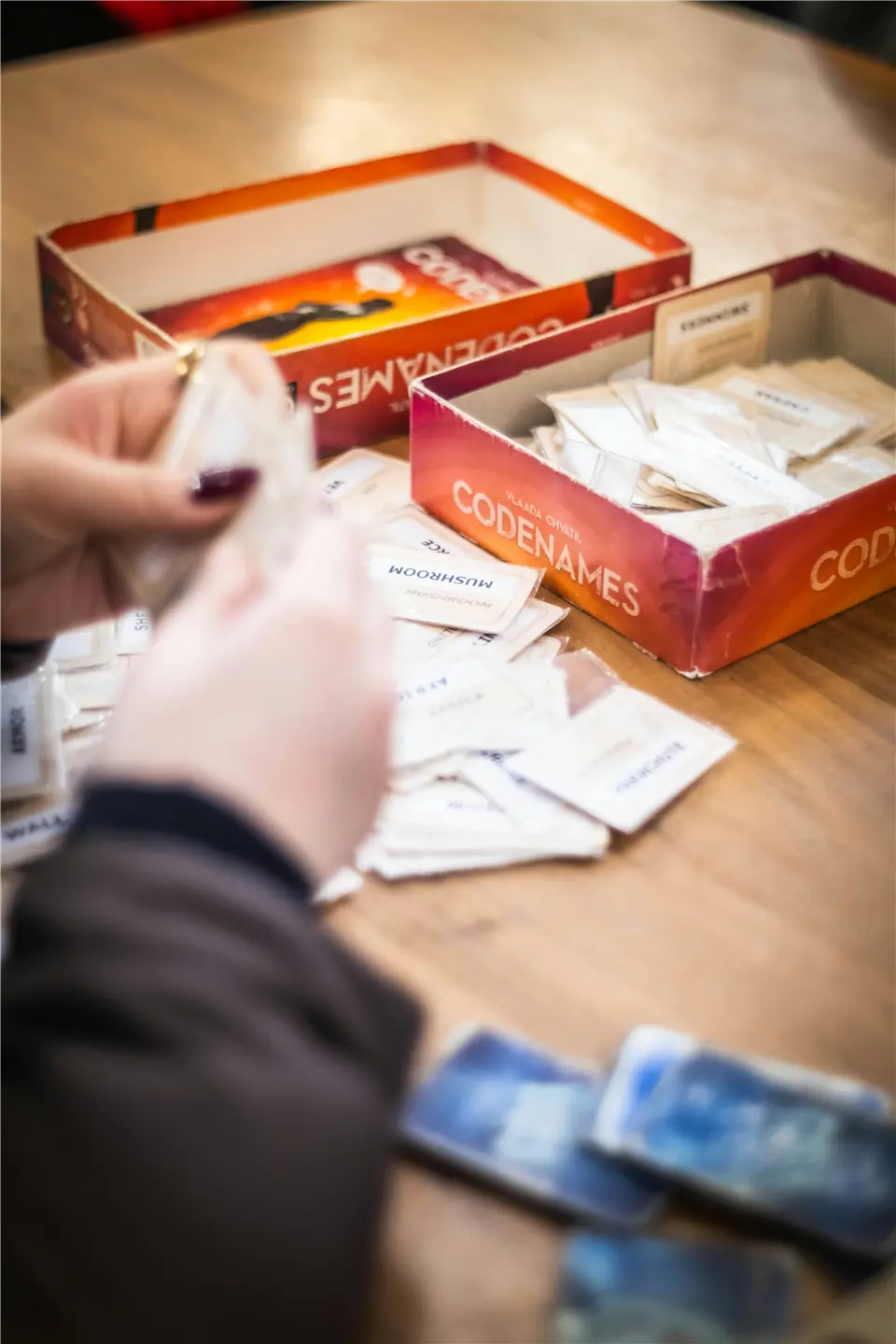 Codenames anahtar kartını inceleyen iki oyuncu
