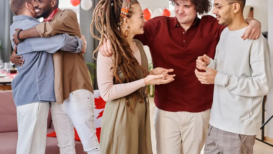 Friends talking in pairs at a small gathering