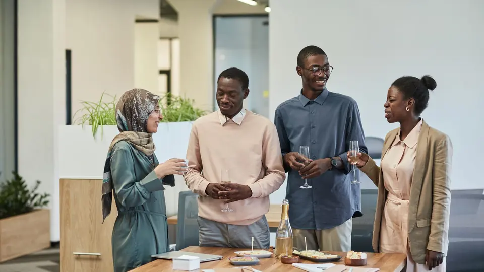 Coworkers talking around an office table
