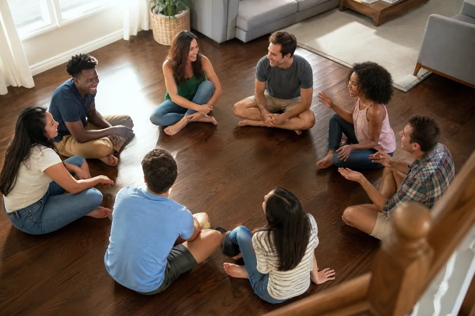 Large group seated in a circle for a quick party game